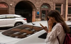 Woman on road looking at her phone