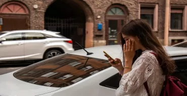 Woman on road looking at her phone